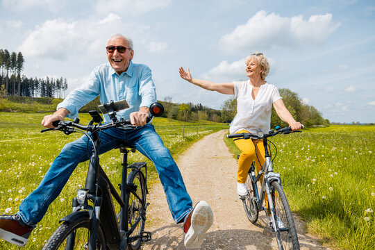 Florida senior couple riding bicycles together on a sunny path